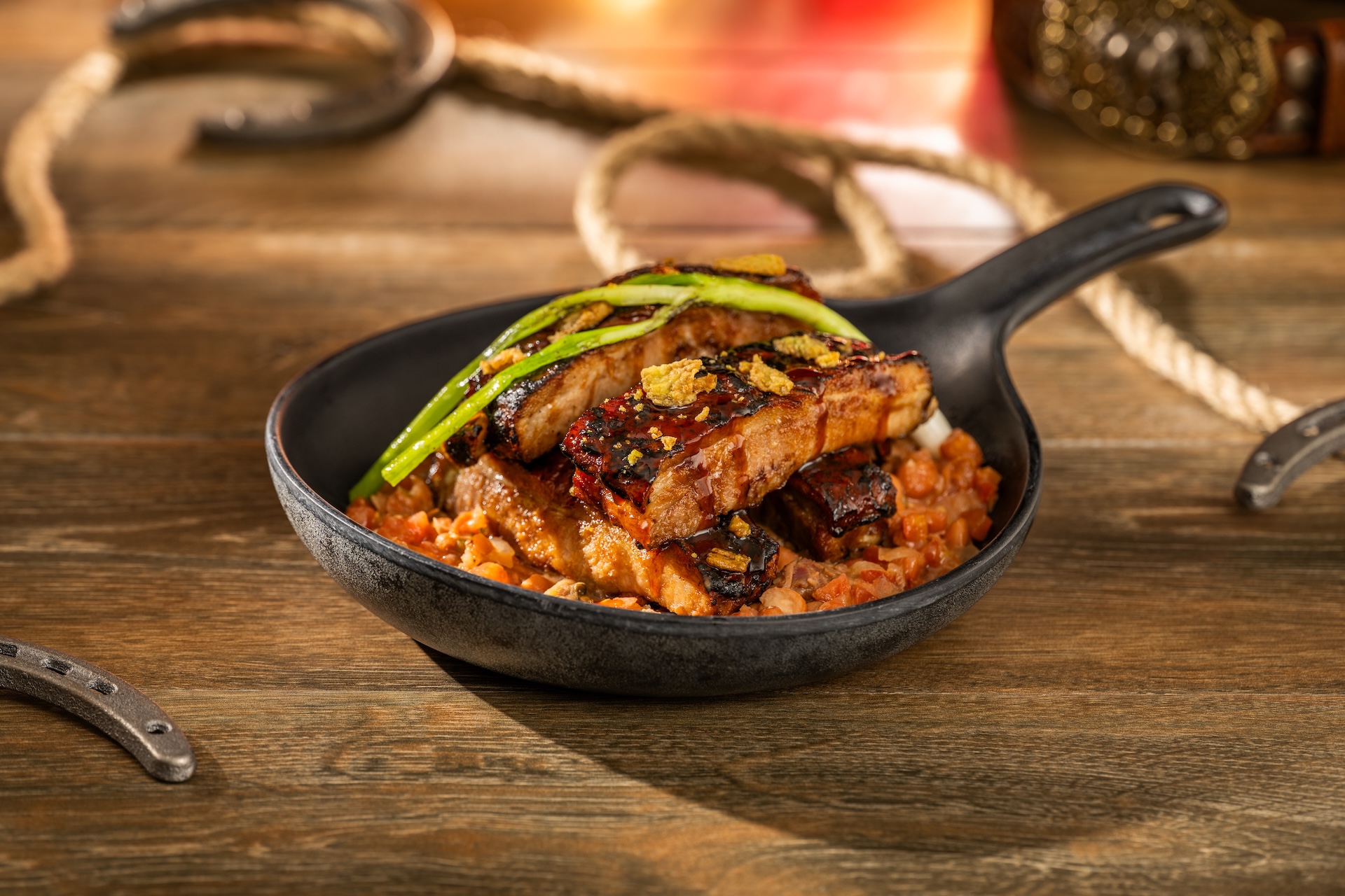Glazed sticky ribs with cowboy beans and jalapeño crisps