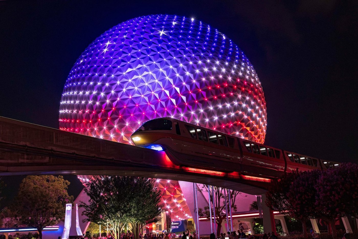 Spaceship Earth lit in red, white, and blue at EPCOT