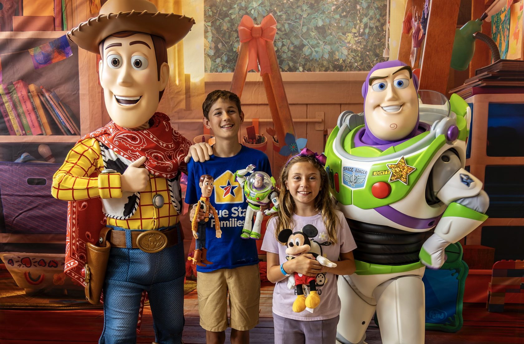 Woody and Buzz Lightyear pose with Blue Star Families children at a Toy Story 5 screening at Camp Pendleton