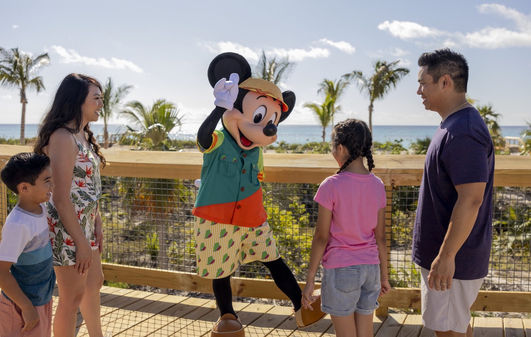 Mickey greeting a family during a Disney Cruise Line voyage