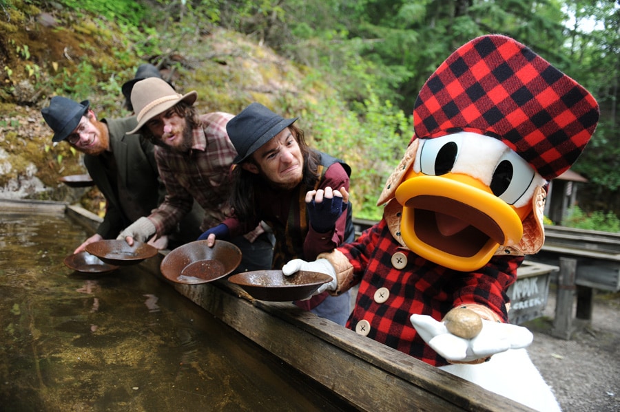 Disney Cruise Line guests pan for gold with Donald Duck during an Alaska Port Adventure