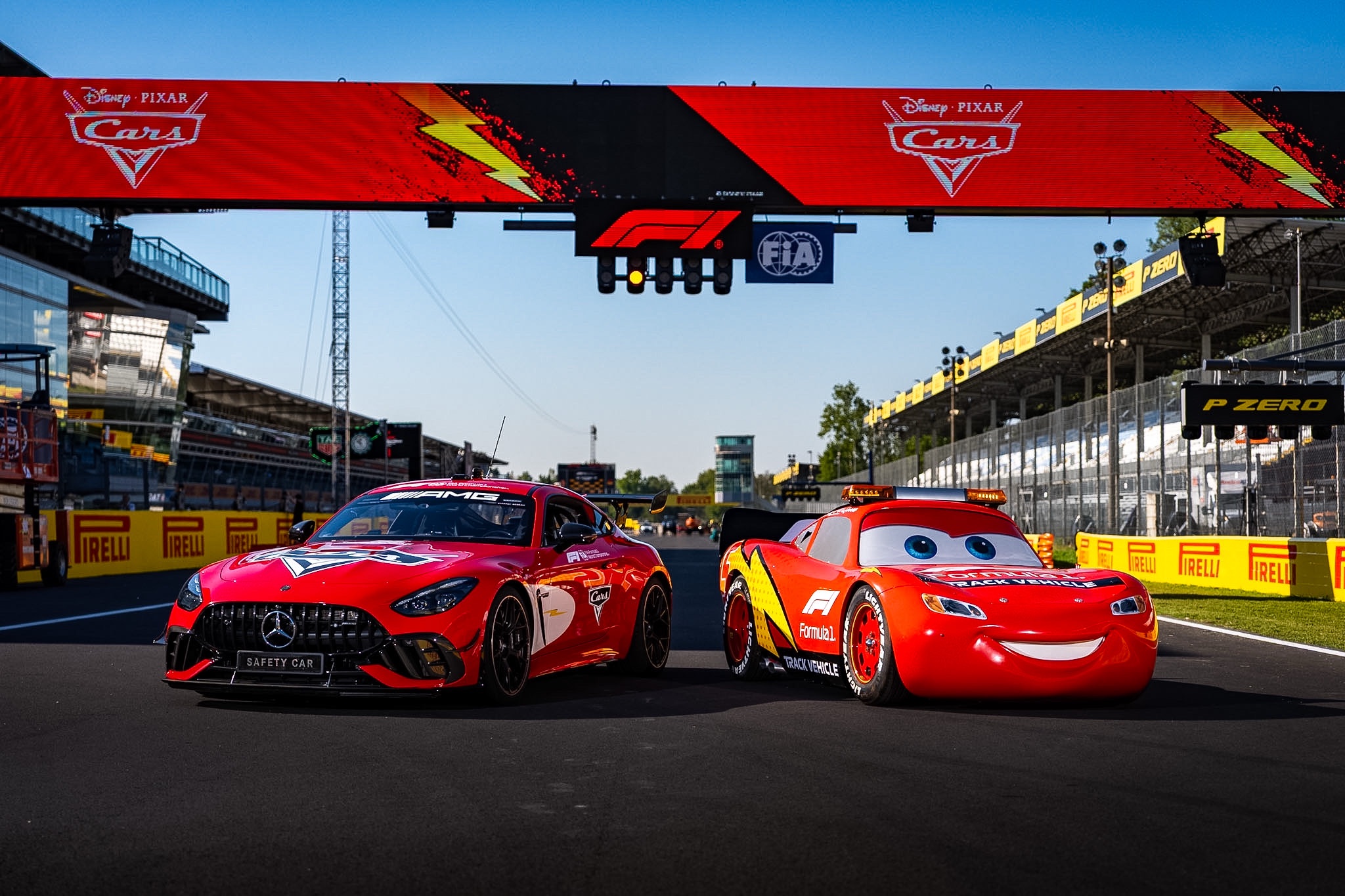 Lightning McQueen beside a Cars-inspired Mercedes-AMG Formula 1 Safety Car at Monza