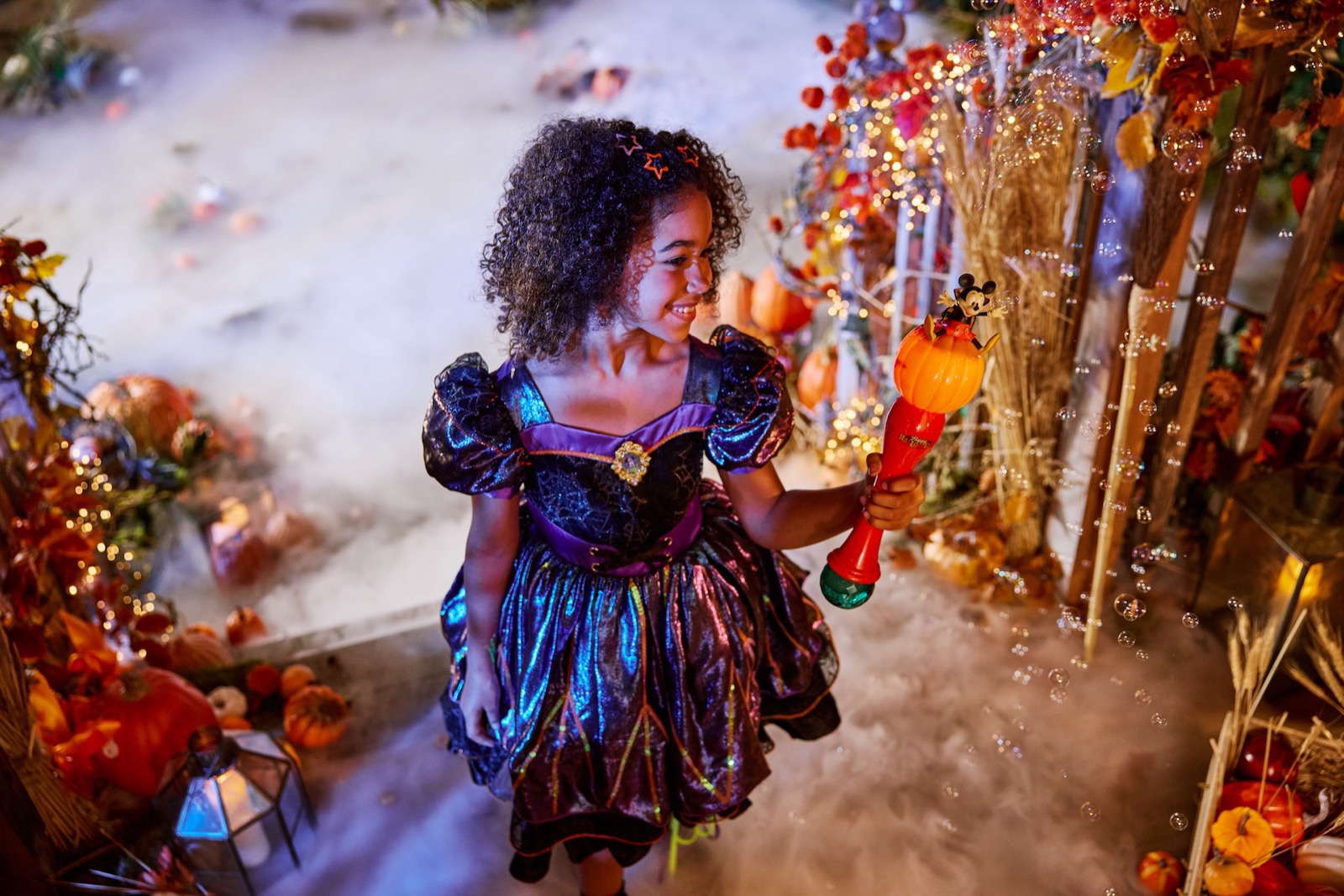 Child wearing a Minnie Mouse witch costume.