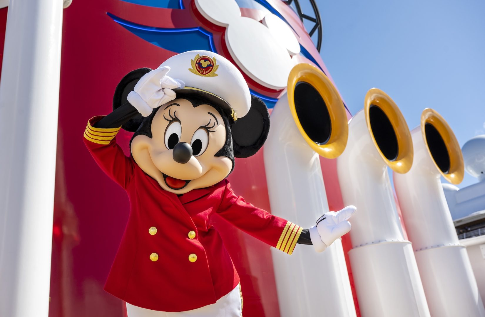 Captain Minnie Mouse salutes beside a Disney Cruise Line ship funnel