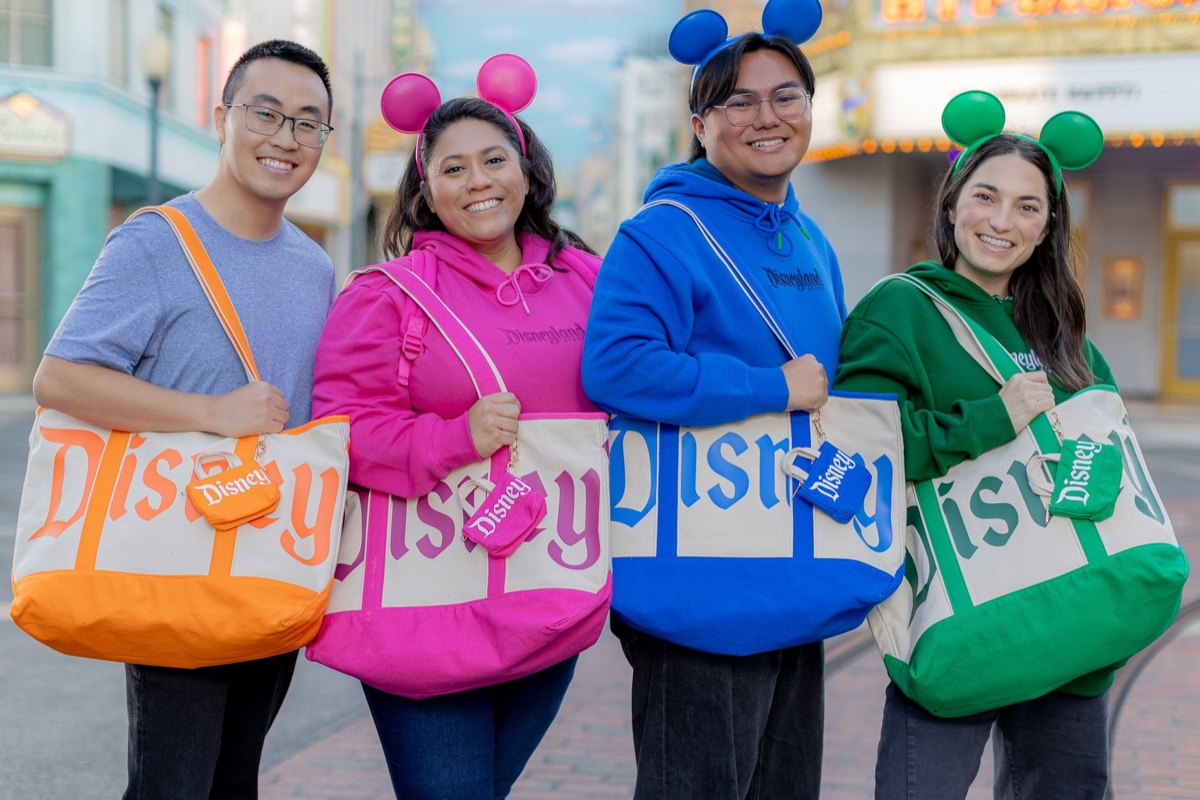 Disney Parks Logo Mania Collection hoodies, oversized totes, wristlets, and Mickey ear headbands in orange, pink, blue, and green