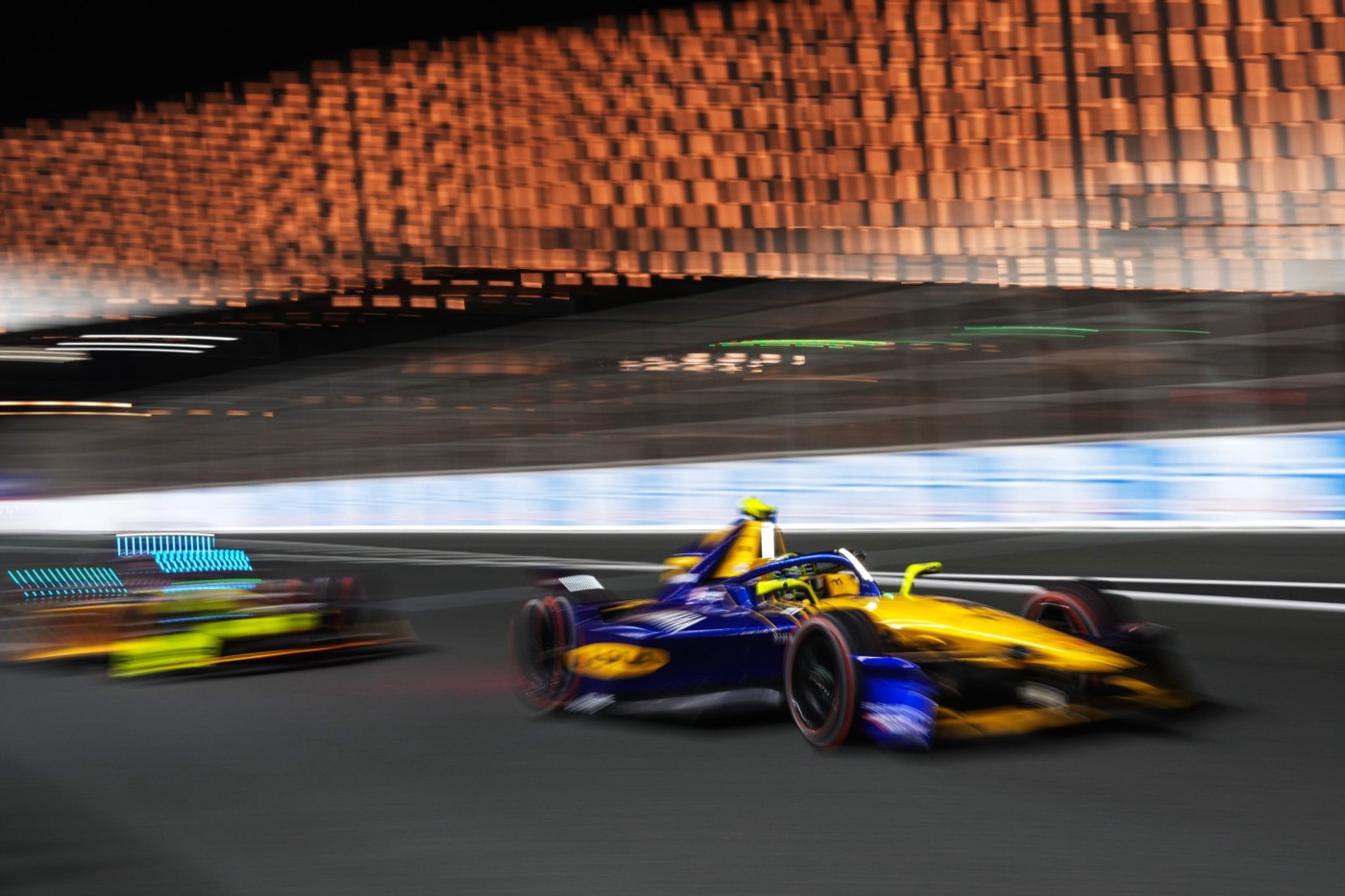 Formula E cars run closely together on track