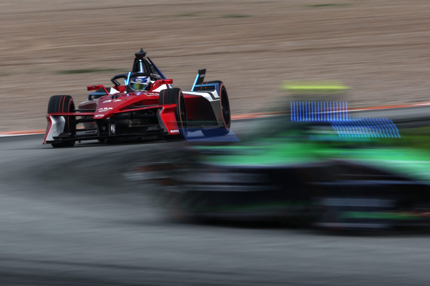 Formula E cars approach a turn on a street circuit