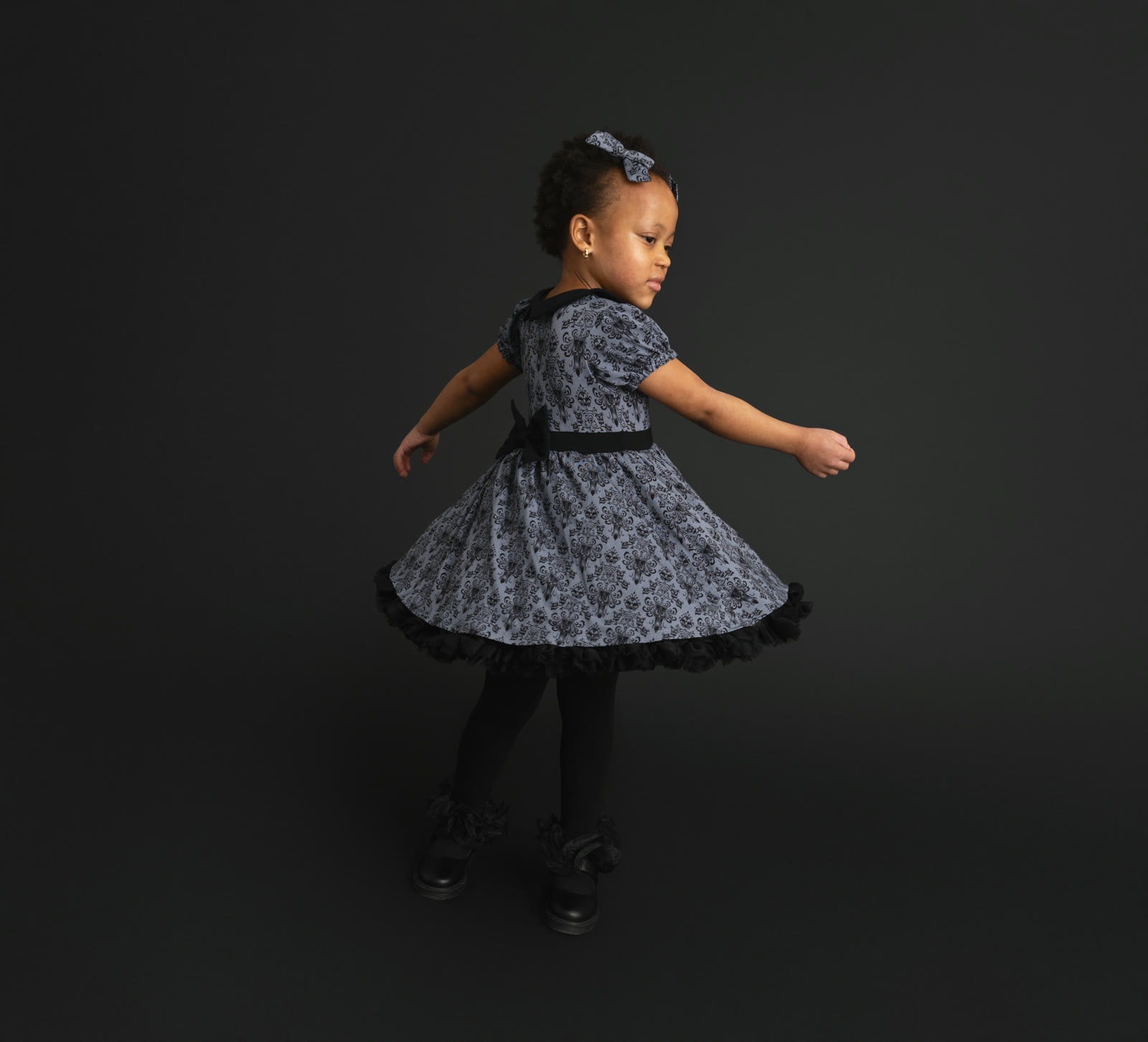 Child wearing a Haunted Mansion wallpaper petticoat dress