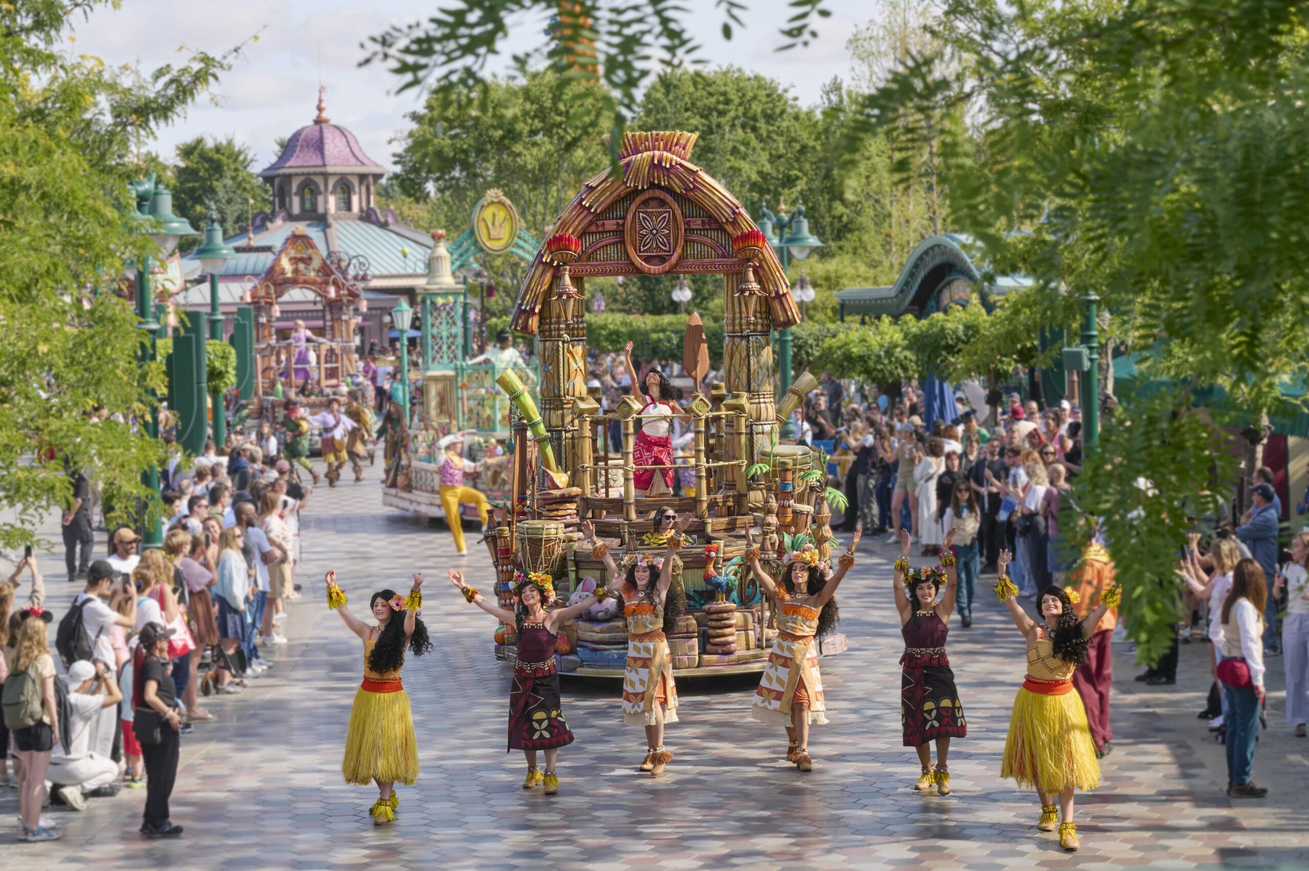 Moana and dancers lead the Disney Princess Cavalcade through Disney Adventure World