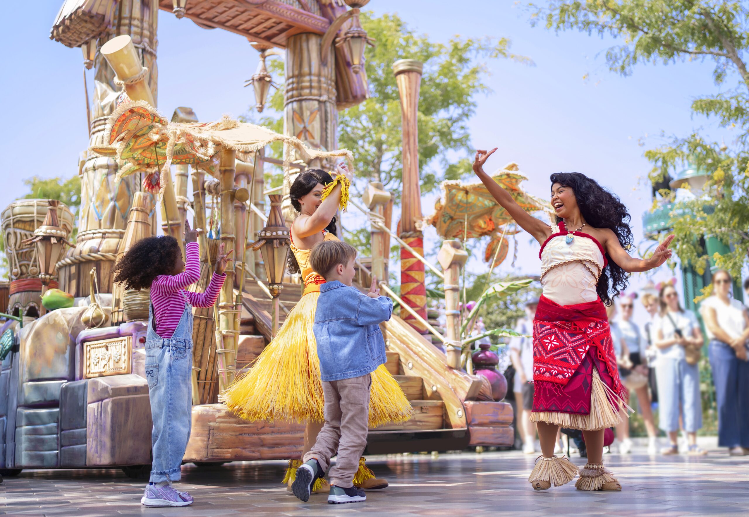 Moana meets two children beside her Disney Princess Cavalcade float