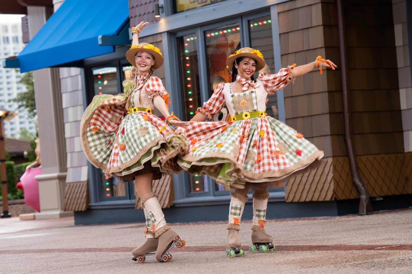 Harvest Skaters perform in orange costumes at Disney Springs