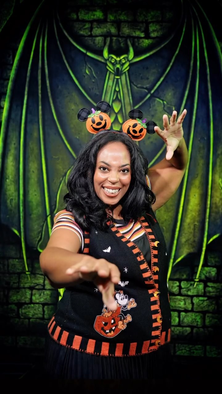 A guest poses inside one of the Disney Villains lairs at the Disney Springs PhotoPass Studio
