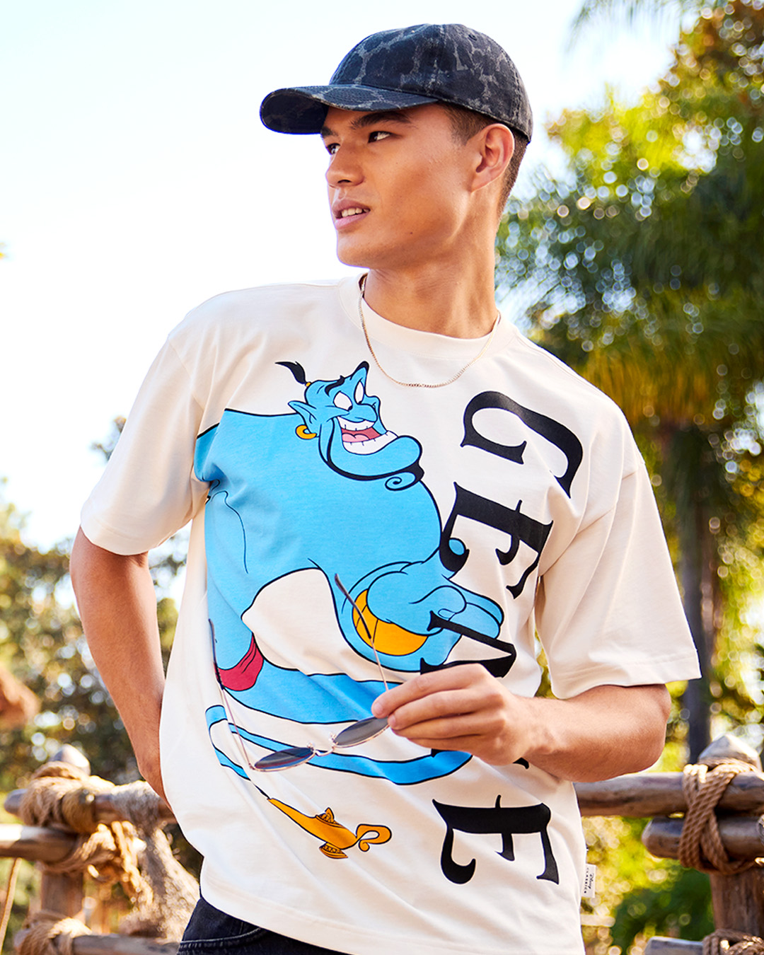 Model wearing a cream Genie T-shirt from the Disney Store Aladdin collection