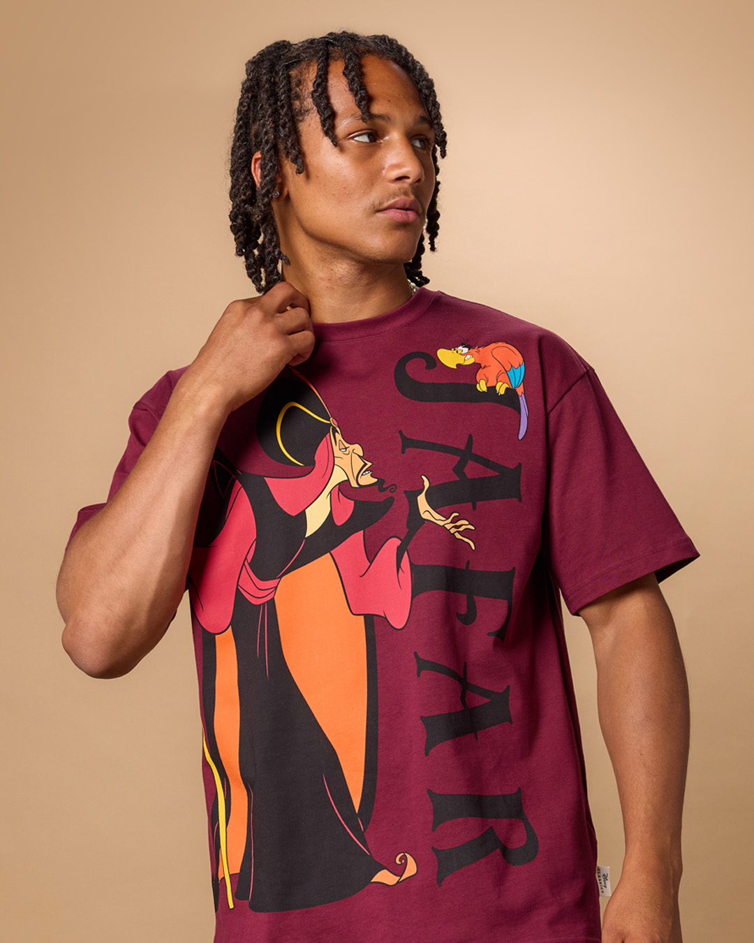 Model wearing a burgundy Jafar and Iago T-shirt from the Disney Store Aladdin collection