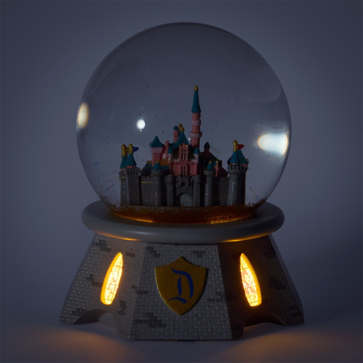 Sleeping Beauty Castle snow globe illuminated
