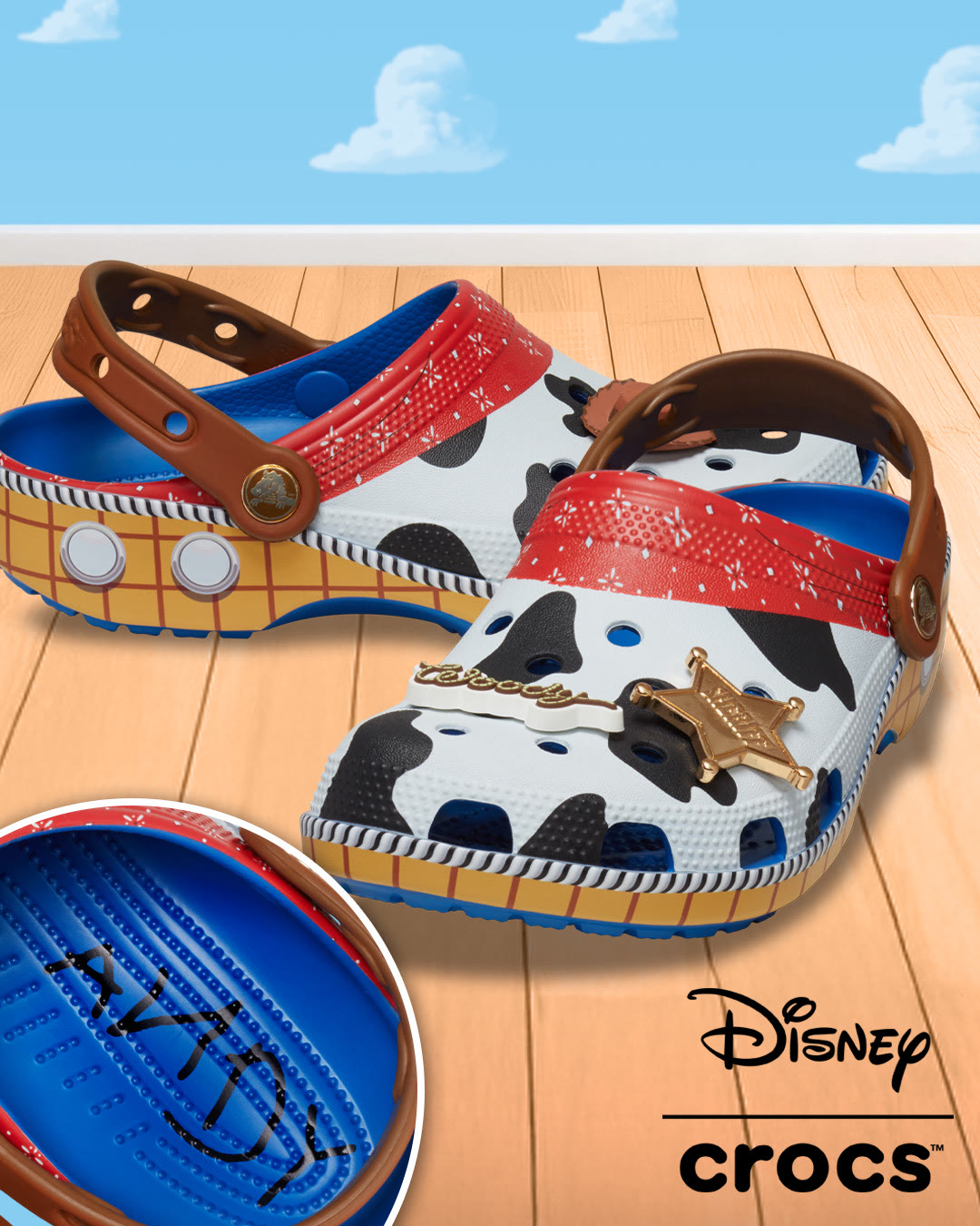 Official Disney Store photo of Woody-inspired Toy Story Crocs with cow print, red bandana straps, sheriff badge charm, and Andy signature