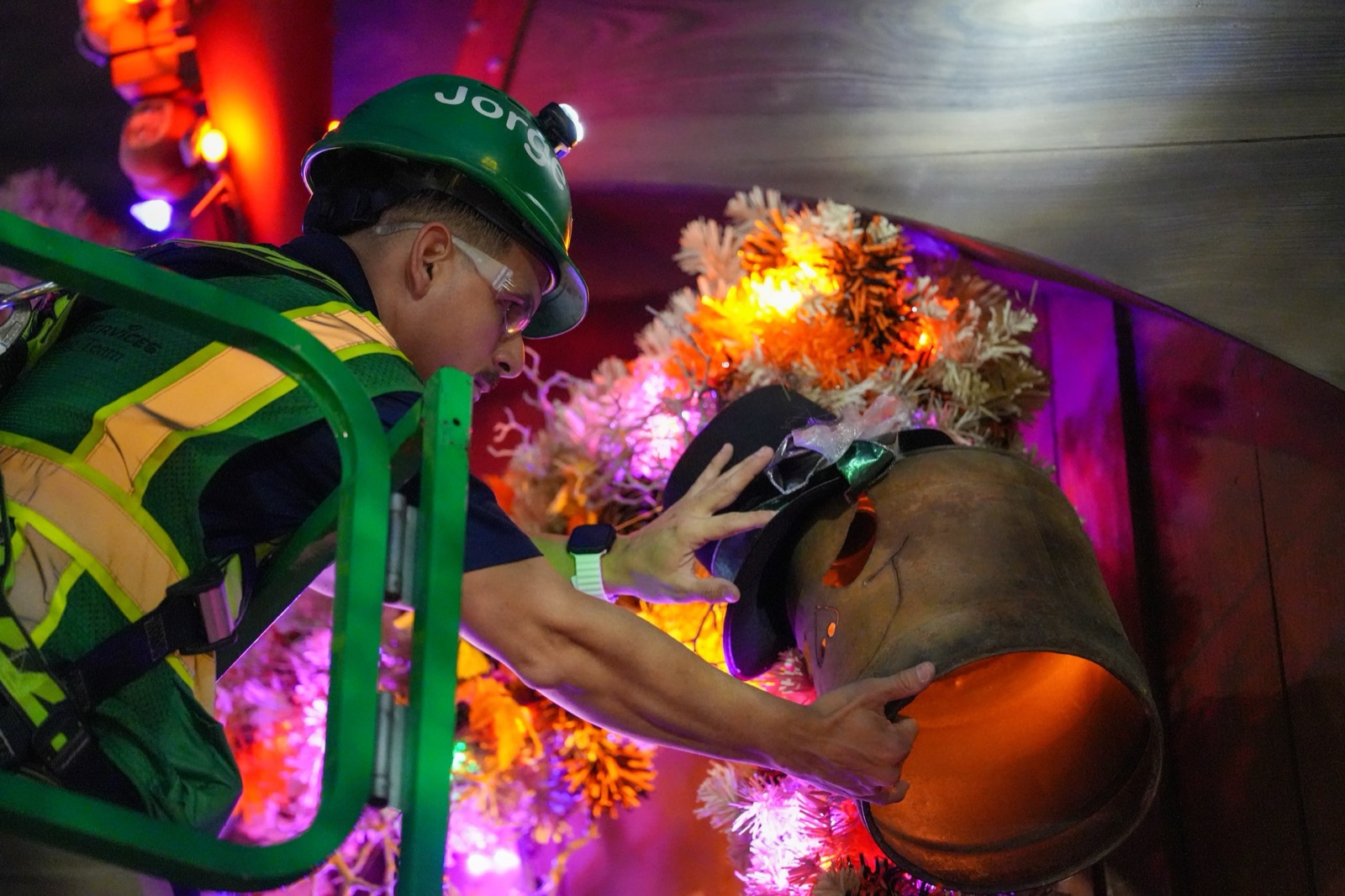 A cast member adjusts a glowing pumpkin at Jock Lindsey’s Hangar Bar