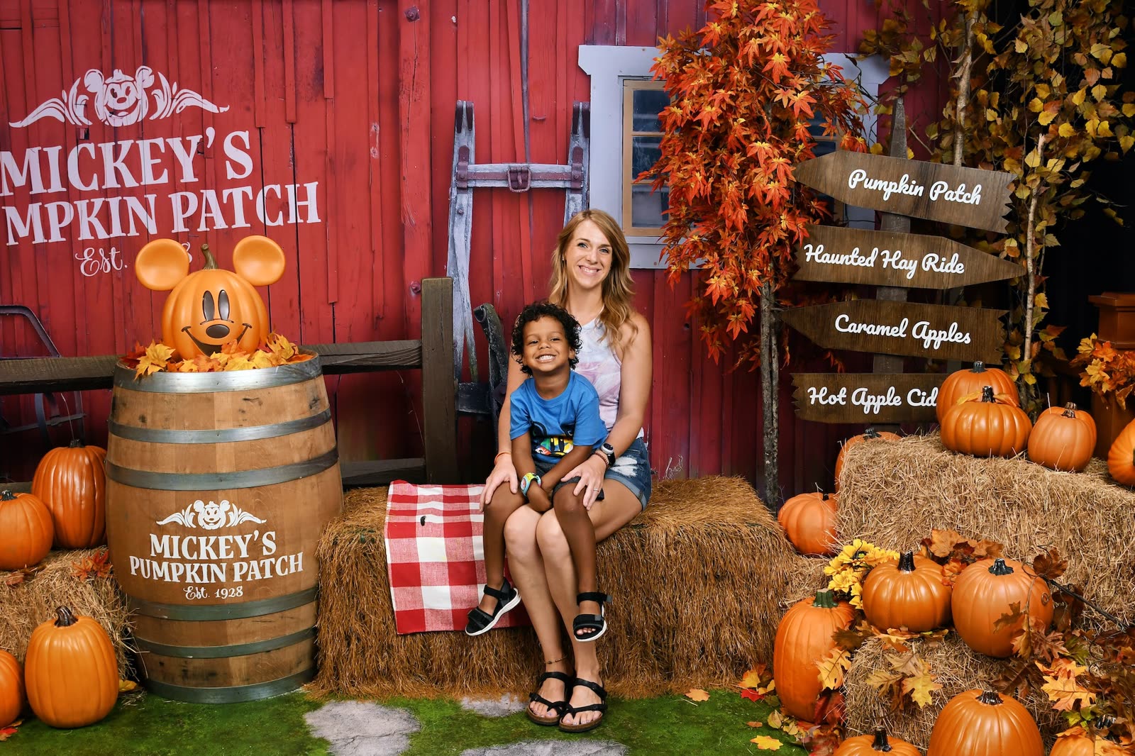 A family poses at a fall backdrop inside the Disney PhotoPass Studio at Disney Springs