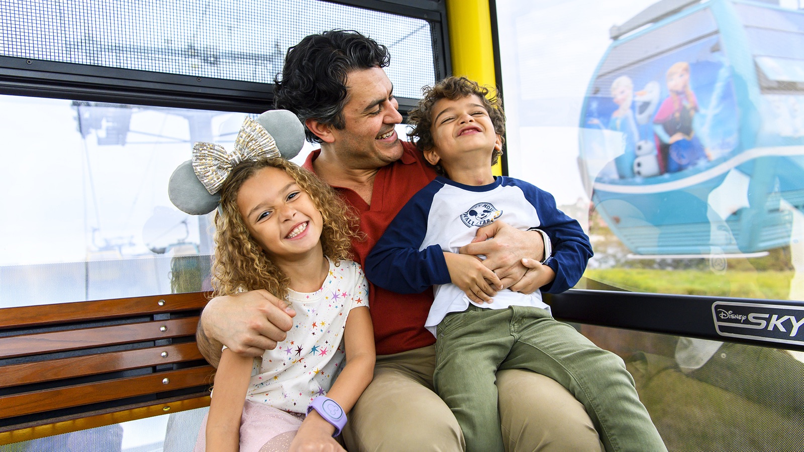 Family riding the Disney Skyliner over Walt Disney World