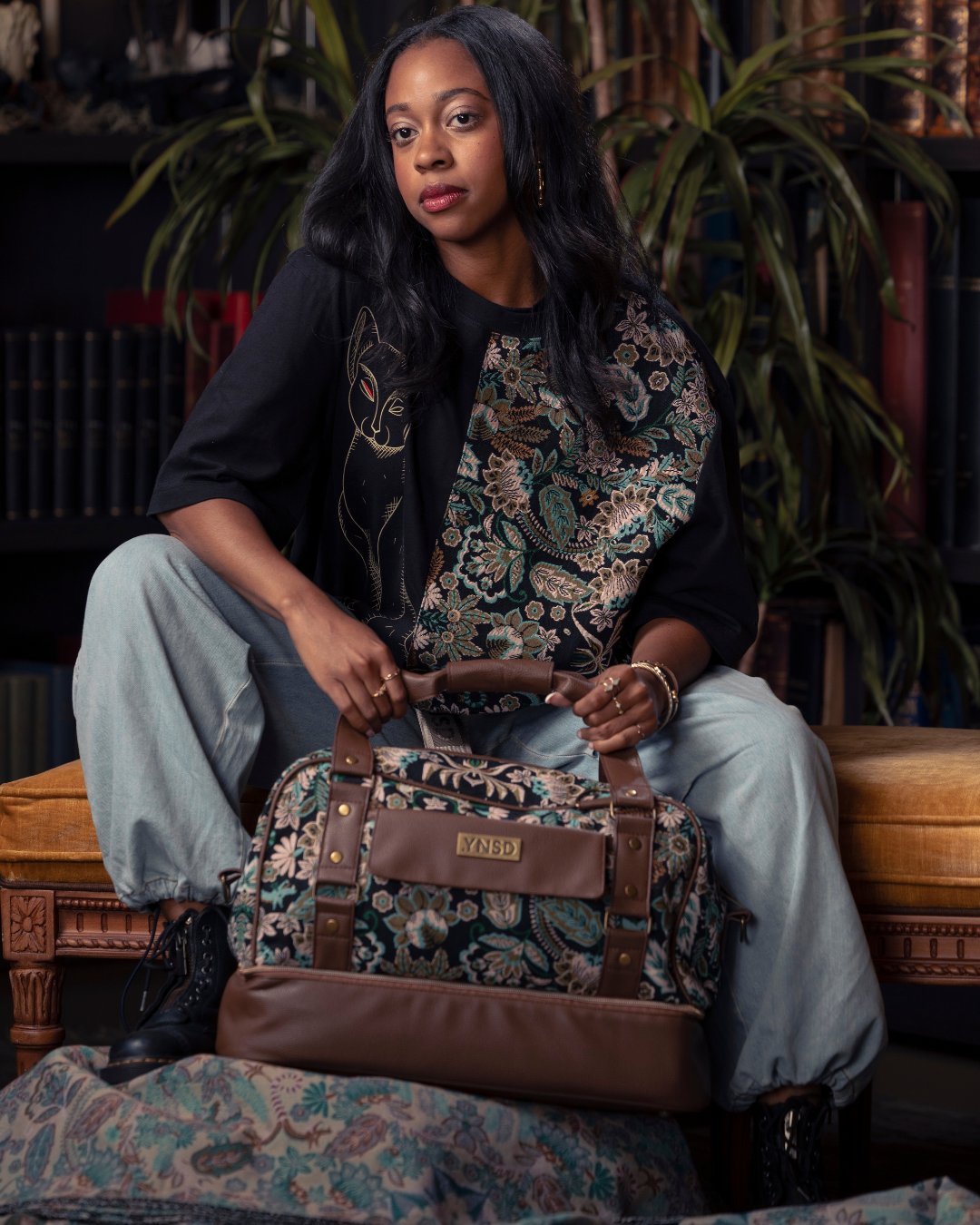 Model carrying a floral Disney .YNSD bag