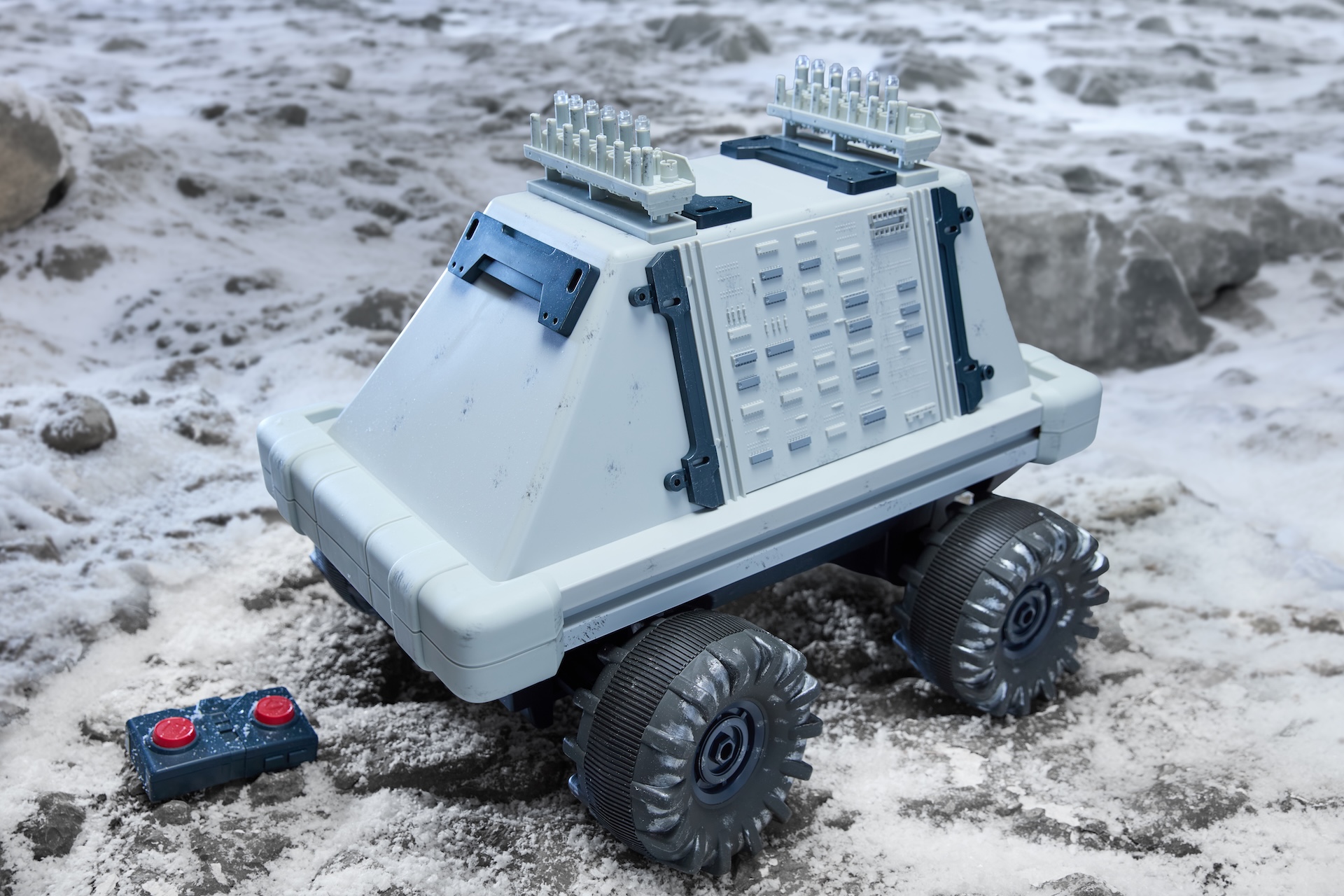White Polar Mouse Droid with remote control on rocky ground
