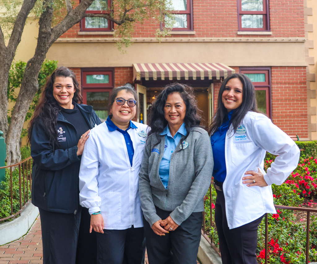 Four Disneyland Resort Health Services cast members outside the Disneyland Park First Aid building.