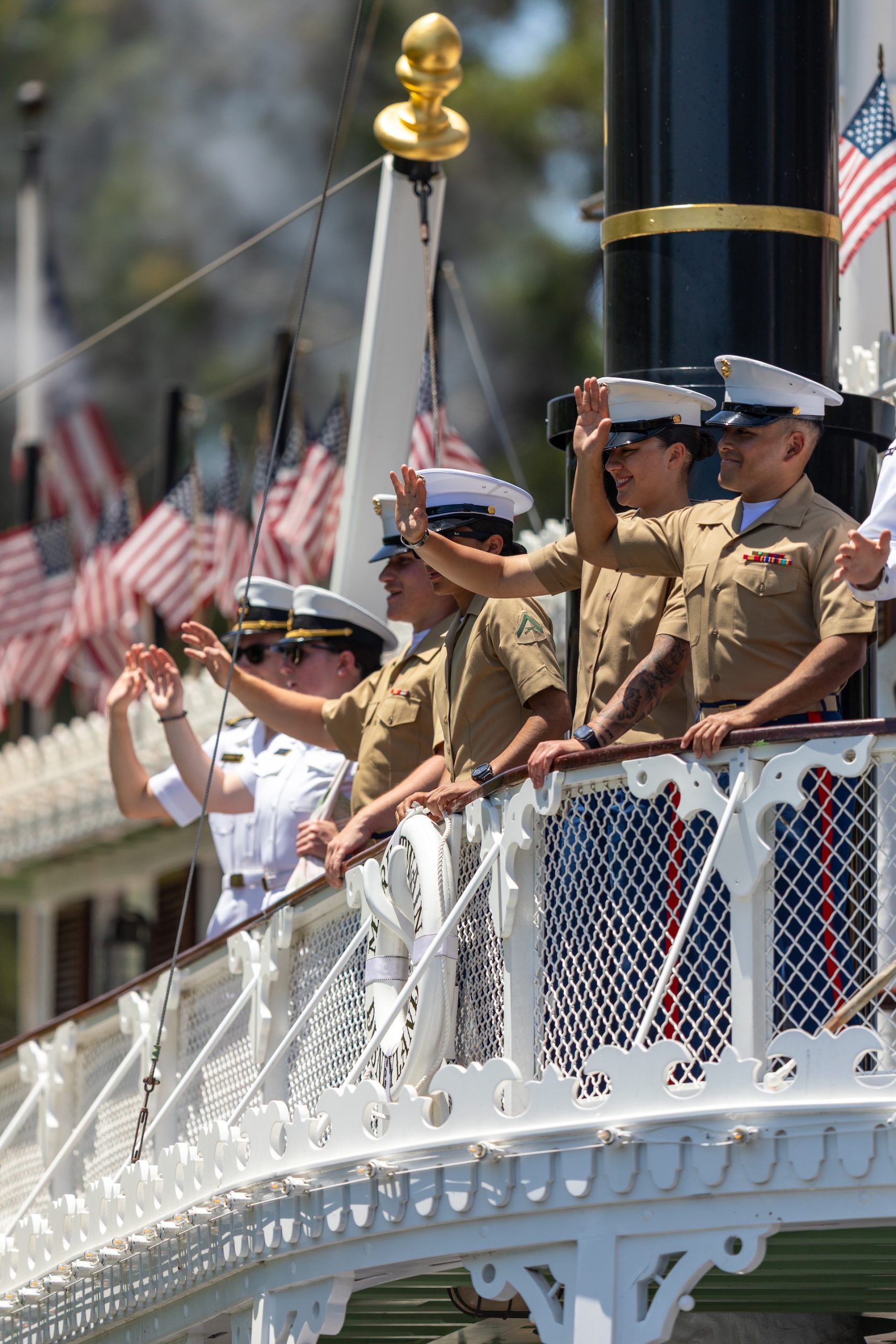 Coast Guard and Navy service members ride the Mark Twain Riverboat during LA Fleet Week at Disneyland