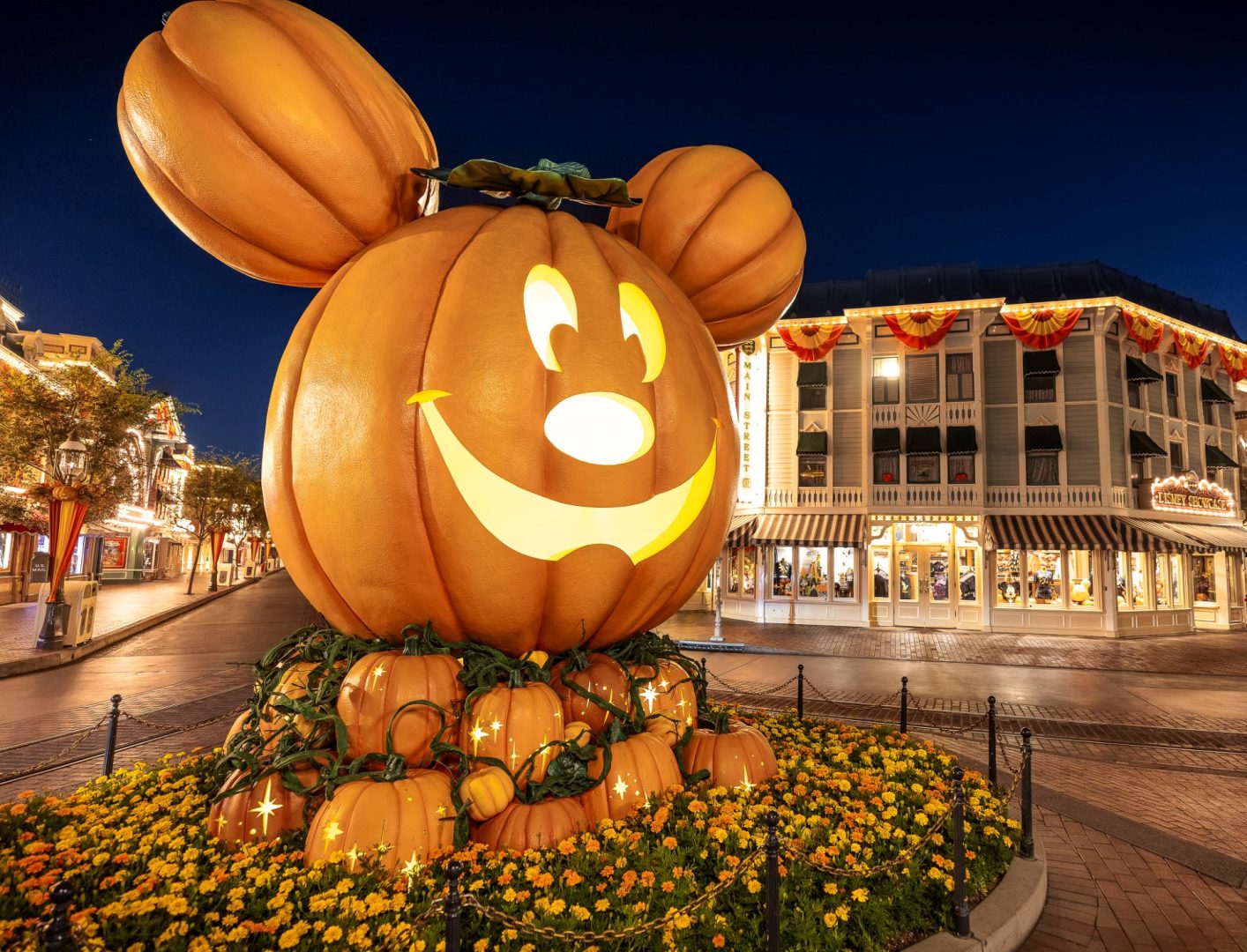 Giant Mickey pumpkin glowing on Main Street at Disneyland Park