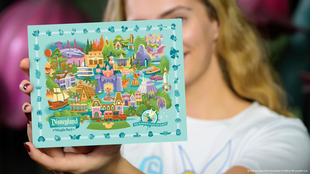Guest holding a Disneyland Resort Magic Key park map activity card