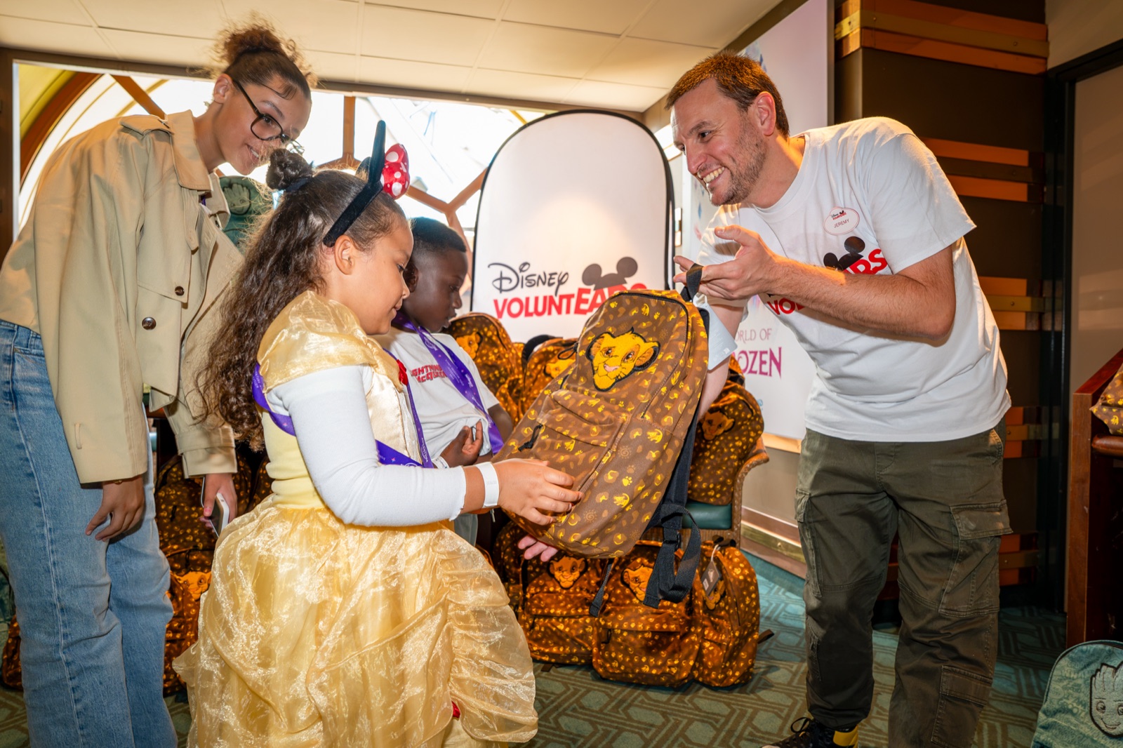 Children receive school supplies from Disney VoluntEARS at Disneyland Paris