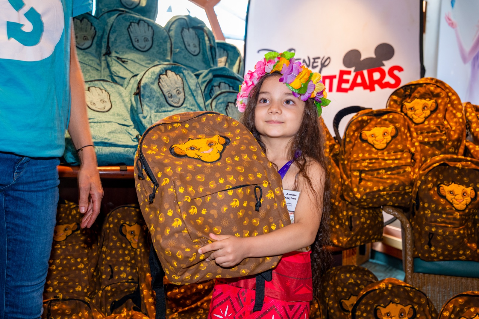 A child holds a Disney backpack during the Disneyland Paris school-kit distribution