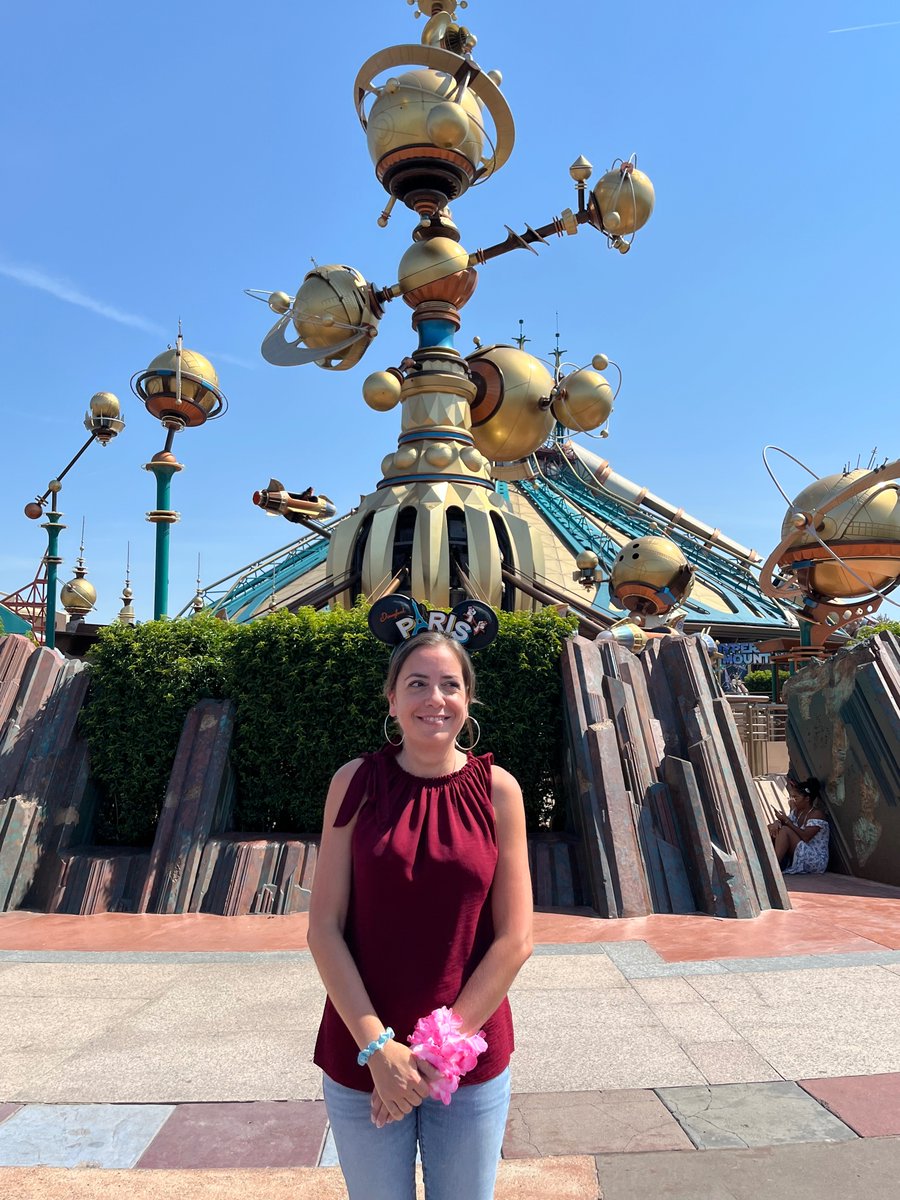 Anne-Lise stands near Orbitron at Disneyland Paris during her return visit