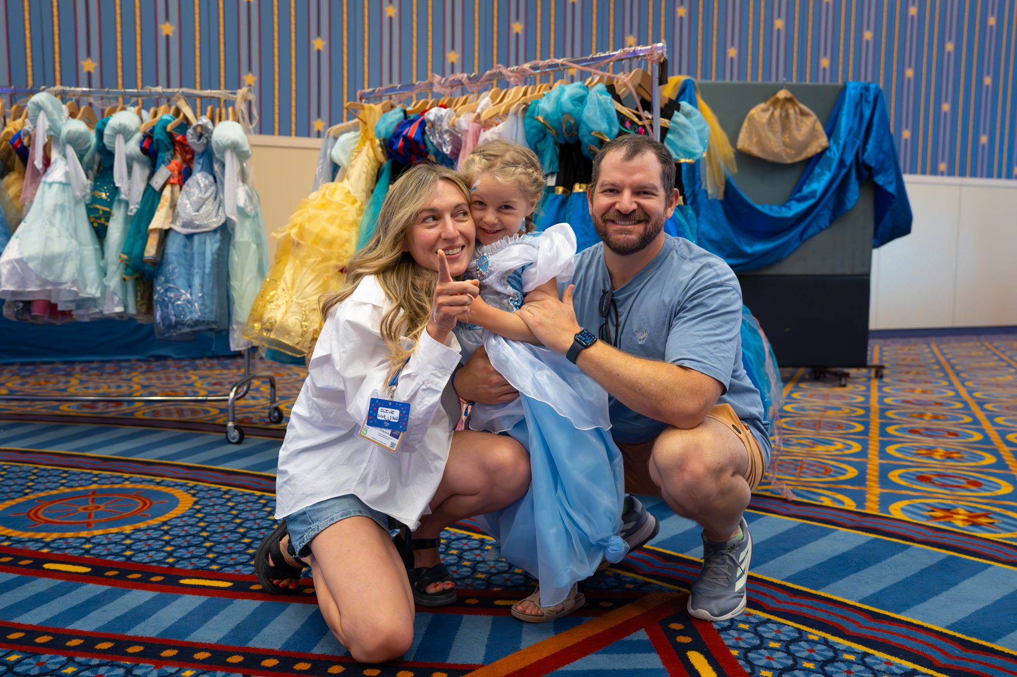 A family poses with a child in a princess dress at Disneyland Paris
