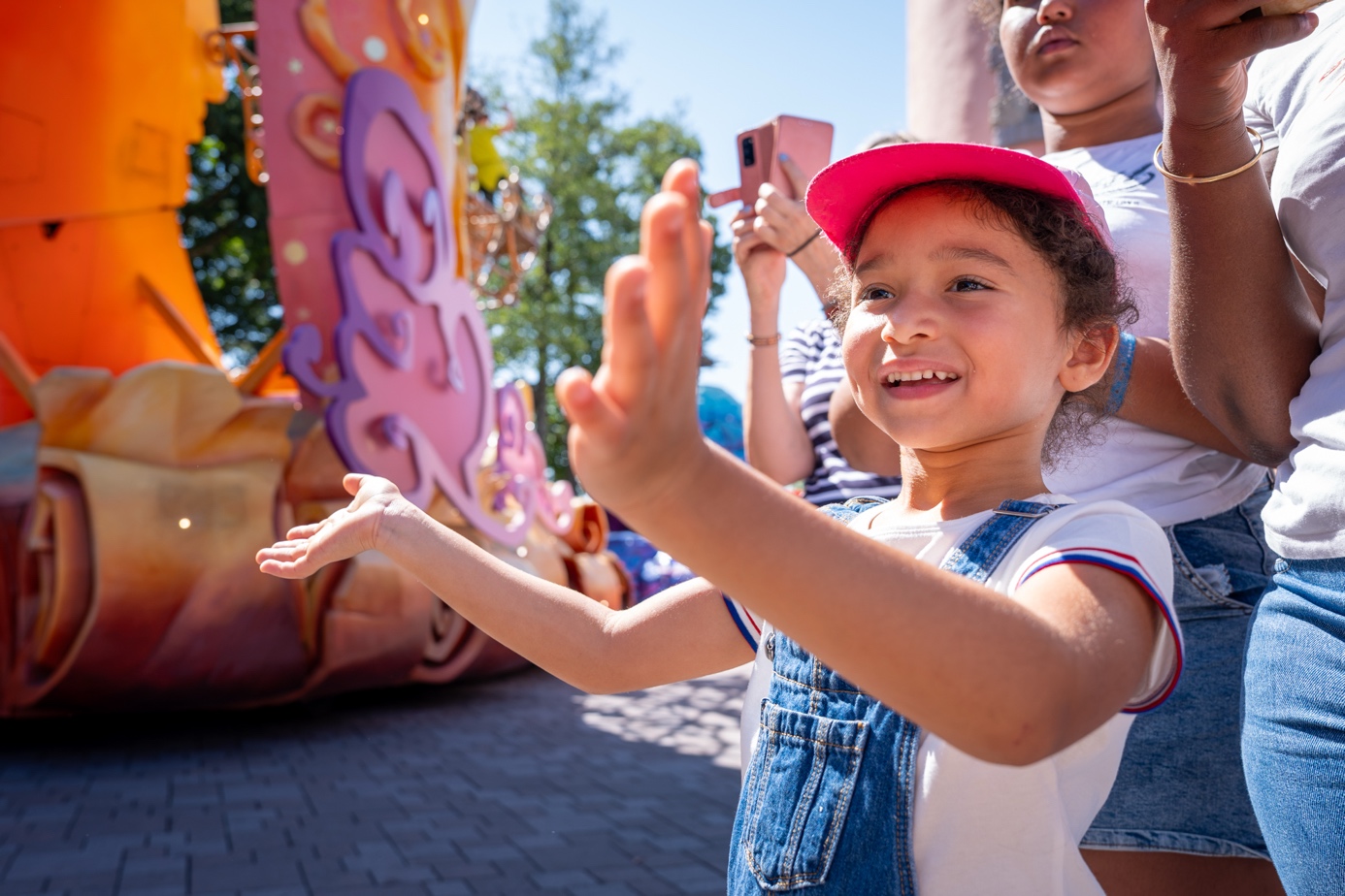 A child waves from a Disneyland Paris parade float