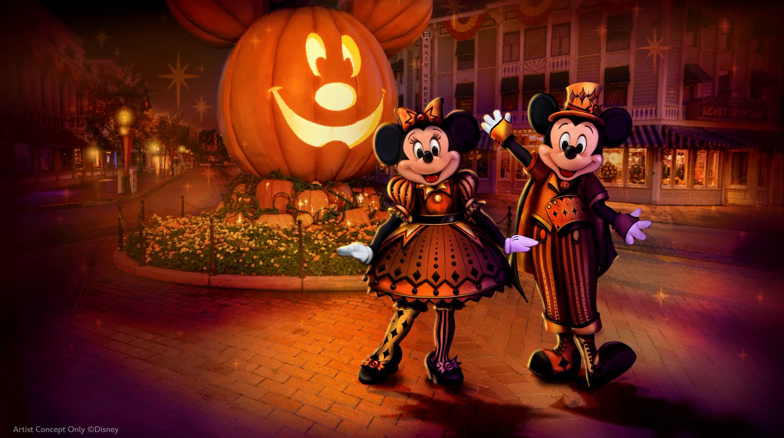 Mickey Mouse and Minnie Mouse in Halloween outfits beside a giant Mickey pumpkin at Disneyland Resort