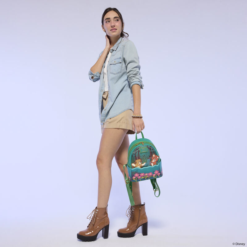 Model carrying the Fox and the Hound mini backpack