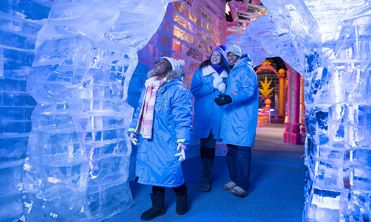 Guests in blue parkas walking through Gaylord Hotels' ICE! attraction