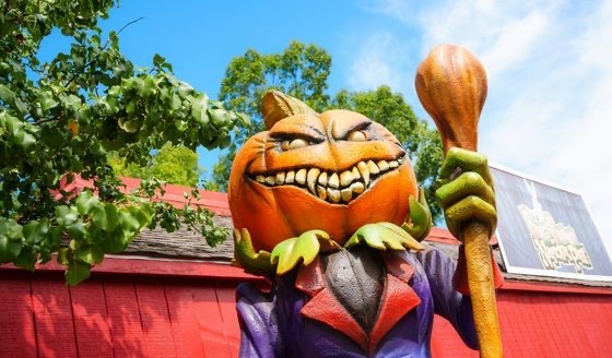 A grinning pumpkin character in the park’s Halloween display.