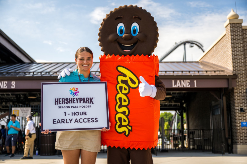 A character and employee welcome guests for Sweet Start.