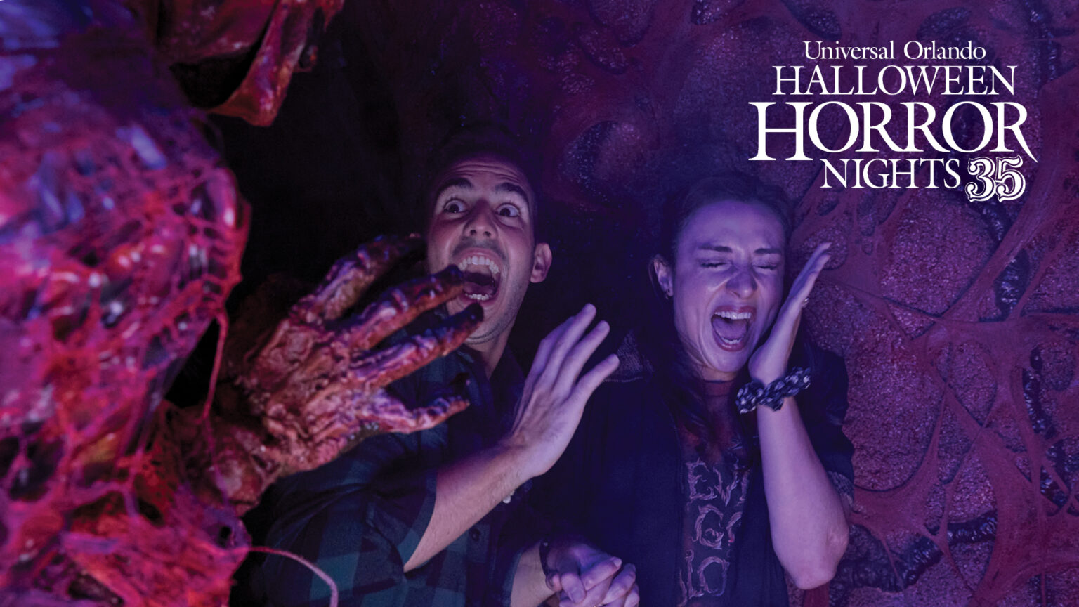 A scareactor reaching toward two screaming guests in official Halloween Horror Nights 35 key art