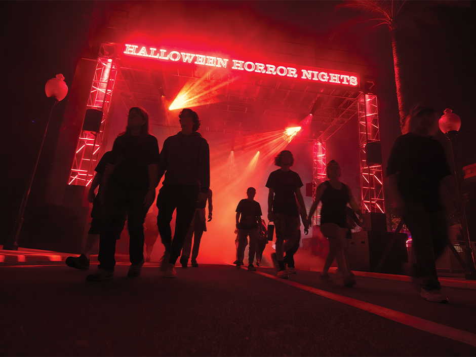 Guests enter Halloween Horror Nights under red lights