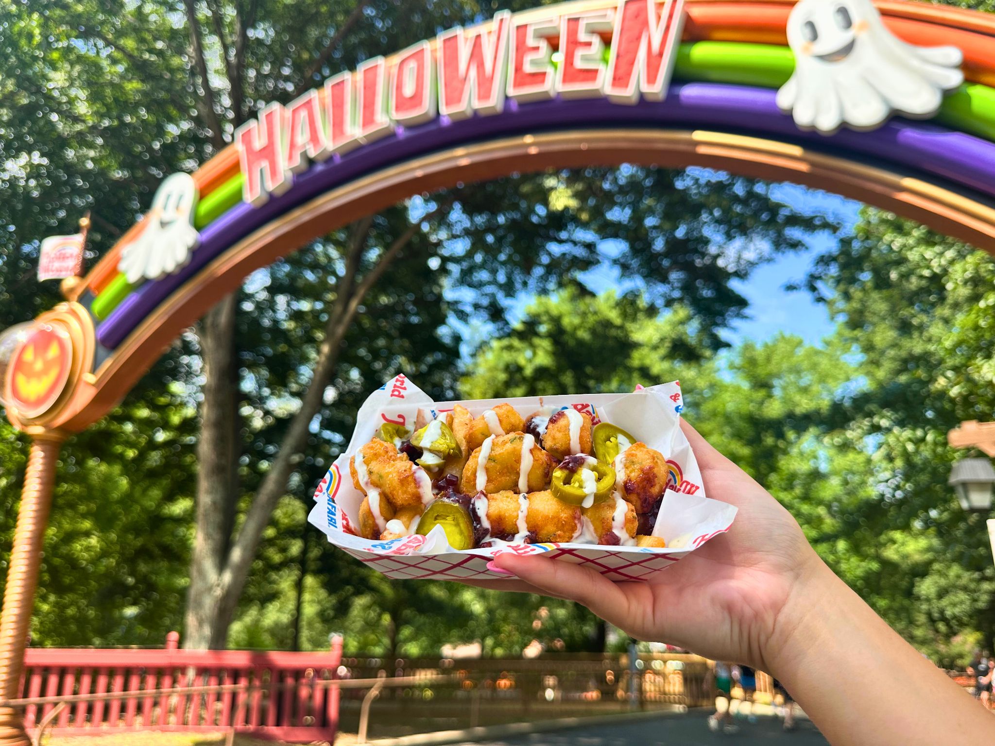 Loaded potato bites served beneath the Happy Halloween arch at Holiday World