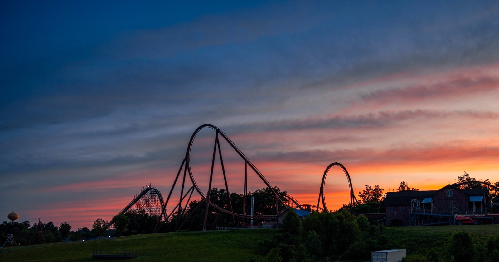 Holiday World roller coasters beneath a stormy sunset