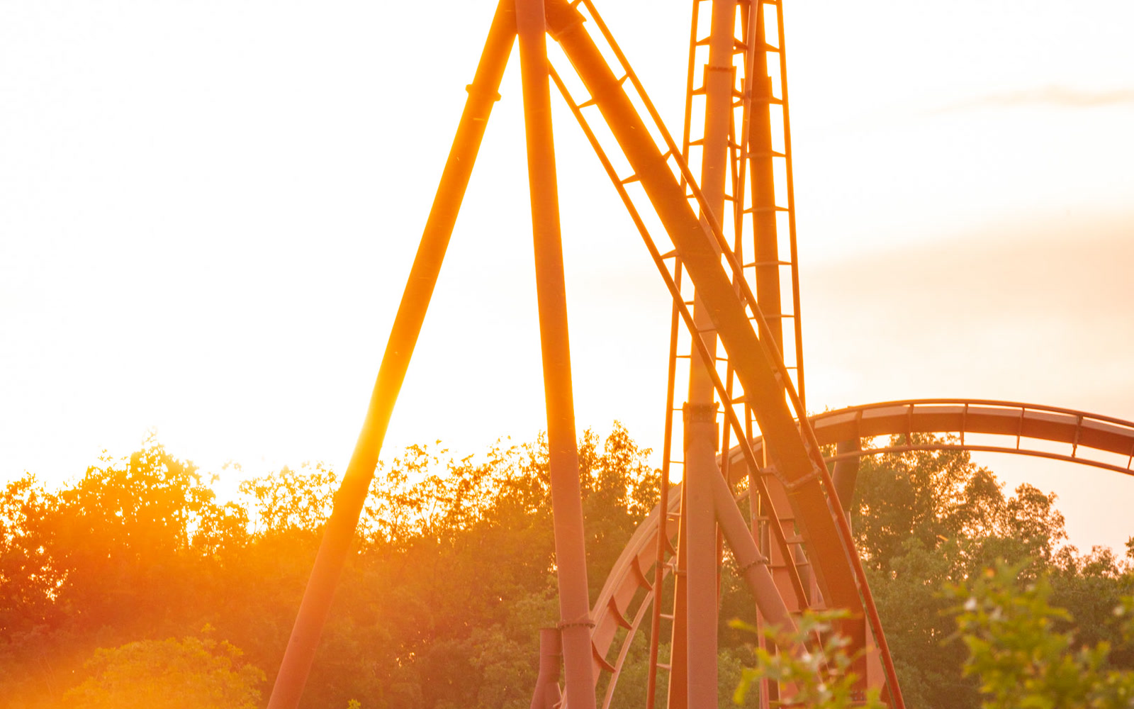 Orange roller coaster track at Holiday World during sunset