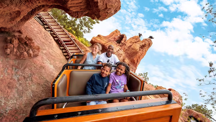 Family riding Big Thunder Mountain at Disneyland Resort