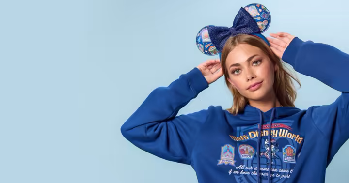 Blue Walt Disney World hoodie and park-icon ear headband in Disney Store's 55th-anniversary preview