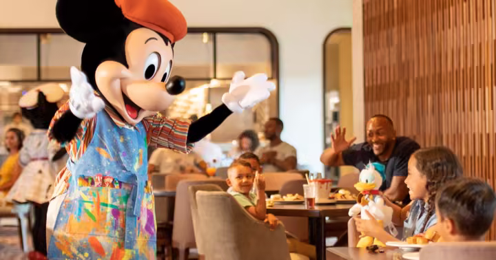Mickey Mouse greets a family at Topolino's Terrace