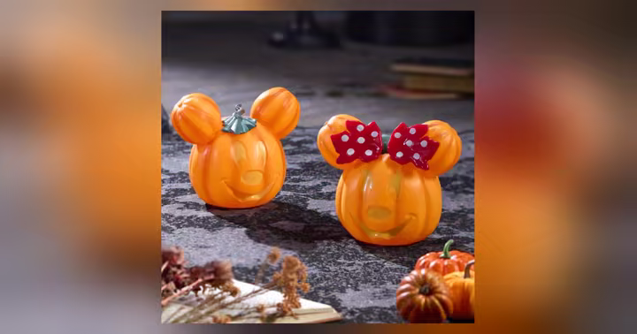Orange Mickey and Minnie jack-o'-lantern decor displayed with other pumpkins