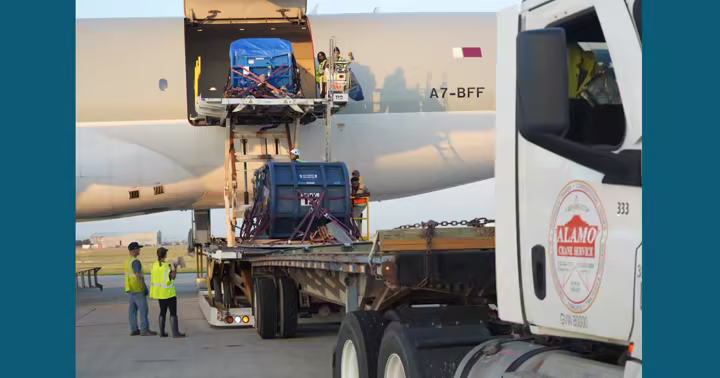 Beluga transport containers are loaded onto an aircraft during an international rescue effort