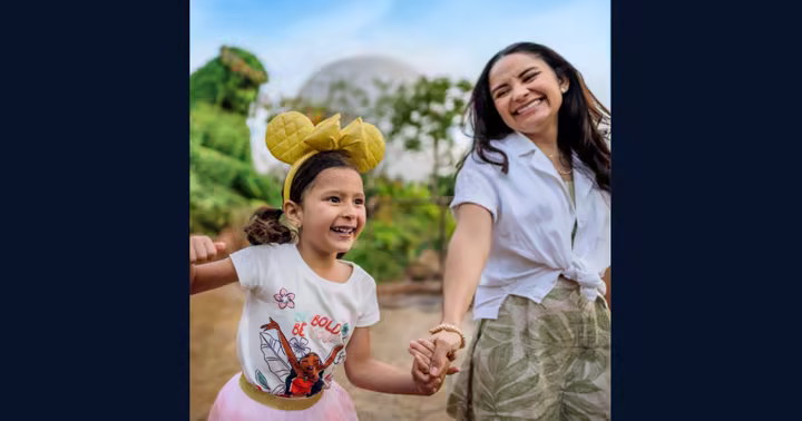 A child and adult wearing Disney headwear at Walt Disney World